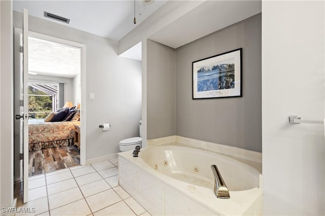 full bath featuring visible vents, toilet, connected bathroom, a tub with jets, and tile patterned floors