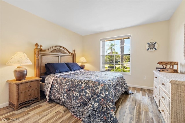 bedroom featuring baseboards and wood finished floors