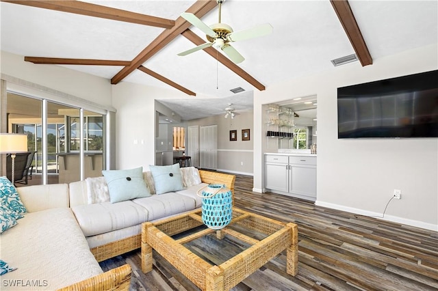 living area with plenty of natural light, wood finished floors, visible vents, and baseboards