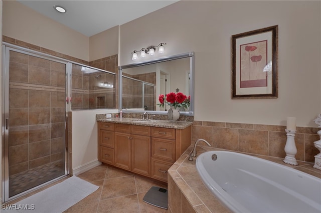 full bath with tile patterned flooring, a bath, vanity, and a stall shower