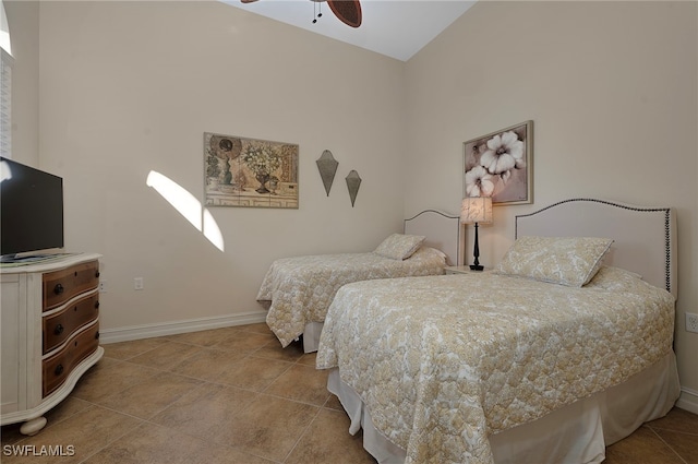 bedroom featuring baseboards, ceiling fan, and tile patterned flooring