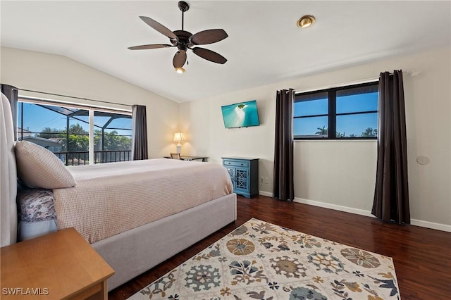 bedroom featuring a ceiling fan, vaulted ceiling, baseboards, and wood finished floors