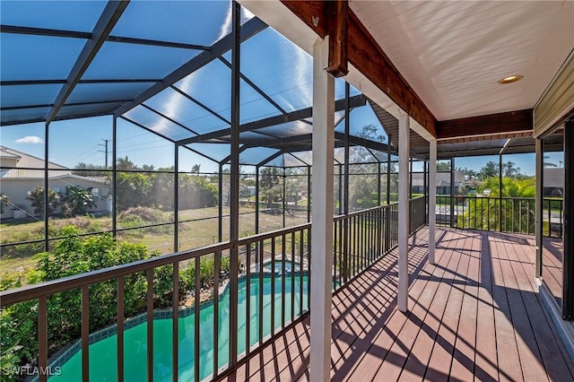 wooden terrace with glass enclosure and a pool with connected hot tub