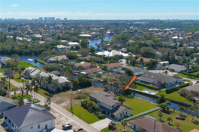 birds eye view of property with a water view and a residential view