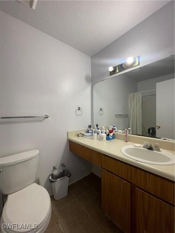 bathroom featuring a shower with shower curtain, toilet, tile patterned flooring, a textured ceiling, and vanity