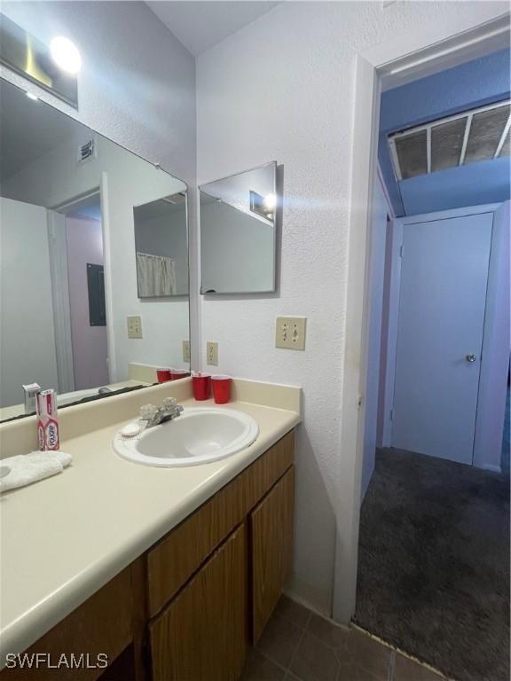 bathroom with visible vents, vanity, and tile patterned floors