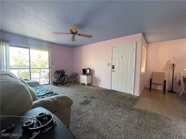 carpeted living area with ceiling fan, a textured ceiling, and tile patterned floors