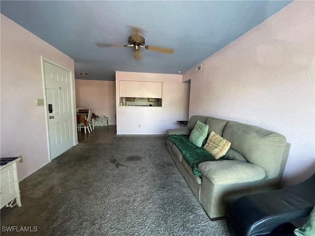 carpeted living room with ceiling fan