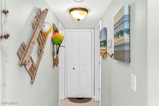 hall featuring light tile patterned floors