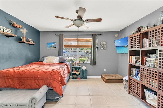 tiled bedroom with a ceiling fan and baseboards