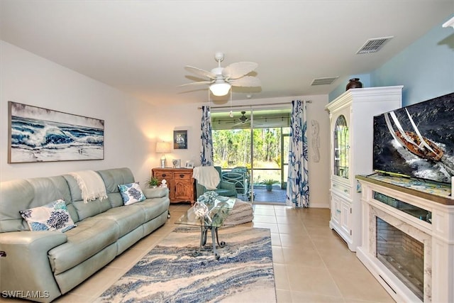 living room with light tile patterned floors, ceiling fan, and visible vents