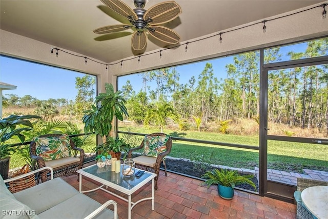 sunroom with a ceiling fan