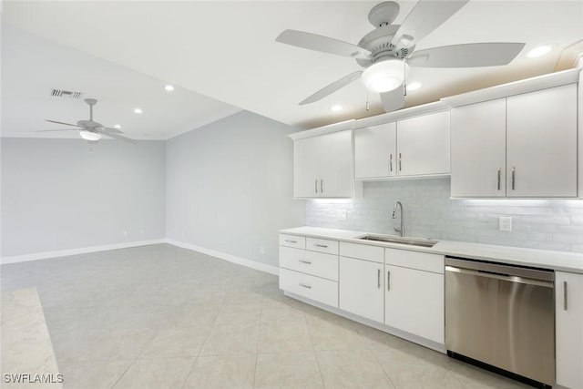 kitchen featuring a sink, visible vents, light countertops, dishwasher, and tasteful backsplash