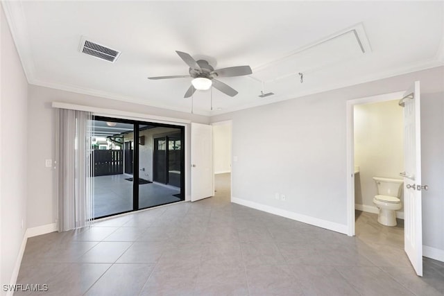 spare room with ceiling fan, visible vents, baseboards, ornamental molding, and tile patterned floors