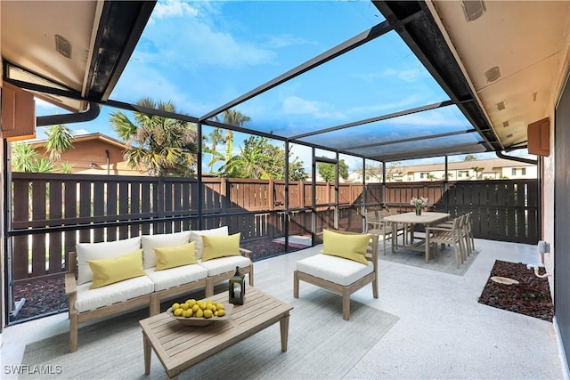 view of patio with an outdoor hangout area, glass enclosure, outdoor dining area, and a fenced backyard