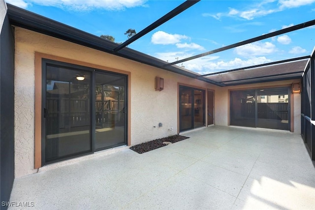 view of patio with glass enclosure