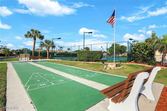 surrounding community with shuffleboard, a yard, fence, and a tennis court