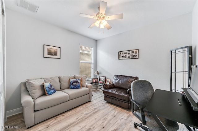 office featuring light wood finished floors, baseboards, visible vents, and a ceiling fan