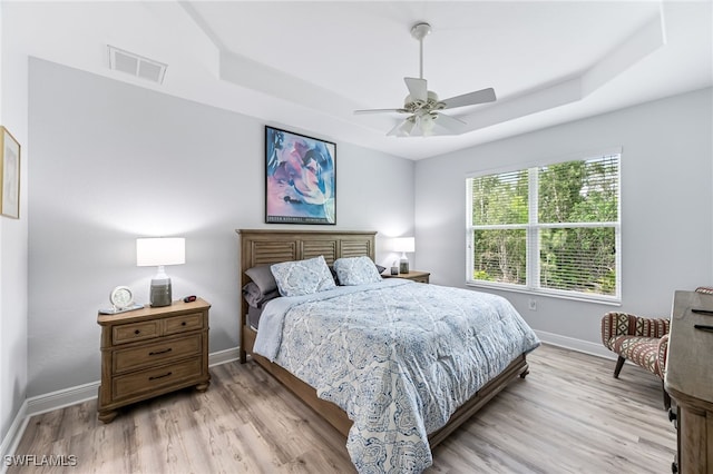8732 Banyan Bay Blvd, Fort Myers, FL 33908 - bedroom featuring a raised ceiling, light wood-style flooring, and ceiling fan