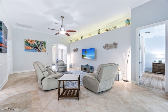 8732 Banyan Bay Blvd, Fort Myers, FL 33908 - living area featuring arched walkways, crown molding, a ceiling fan, and light tile patterned flooring
