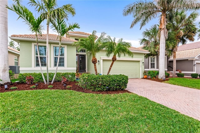 8732 Banyan Bay Blvd, Fort Myers, FL 33908 - view of front of property featuring a tiled roof, stucco siding, decorative driveway, and a garage