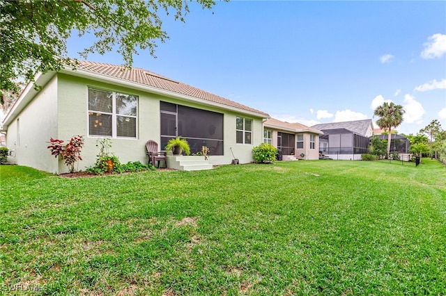 8732 Banyan Bay Blvd, Fort Myers, FL 33908 - back of property featuring stucco siding, a lawn, and a tile roof