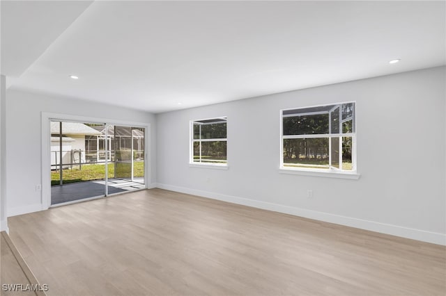 unfurnished room featuring light wood-style floors, recessed lighting, and baseboards