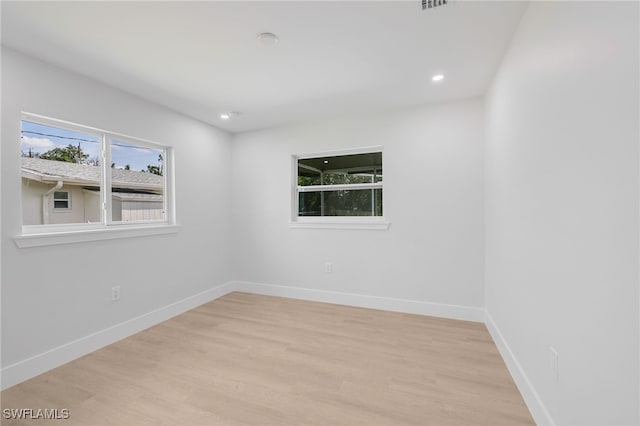 empty room with baseboards, recessed lighting, visible vents, and light wood-style floors