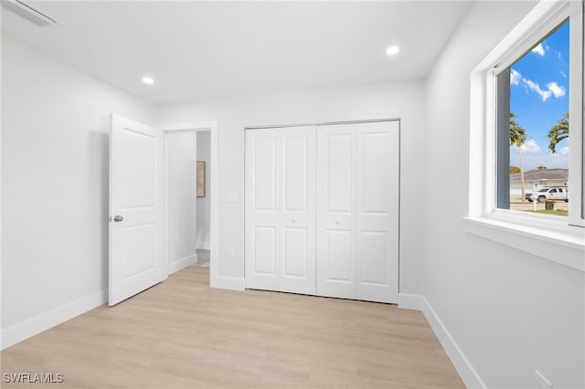 unfurnished bedroom with recessed lighting, light wood-type flooring, visible vents, and baseboards