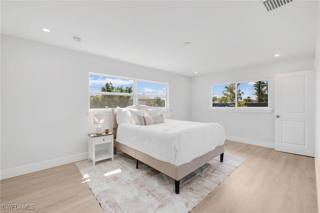 bedroom featuring recessed lighting, multiple windows, light wood-style flooring, and baseboards