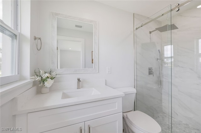 full bath with visible vents, toilet, vanity, and a marble finish shower