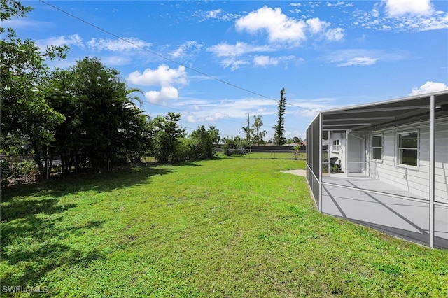 view of yard featuring glass enclosure