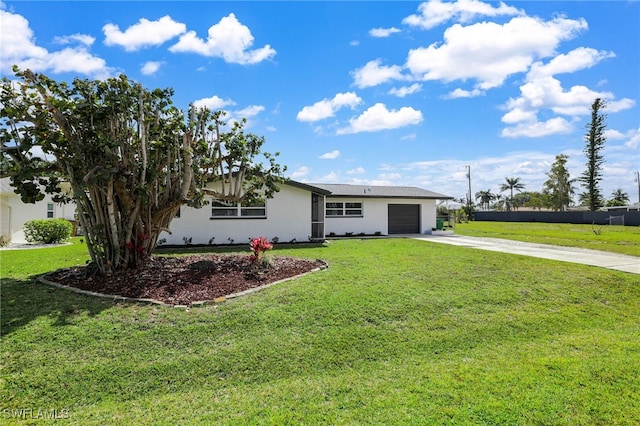 ranch-style house featuring a front yard, concrete driveway, an attached garage, and stucco siding