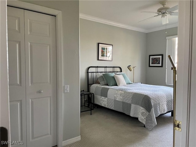 carpeted bedroom with a ceiling fan and crown molding