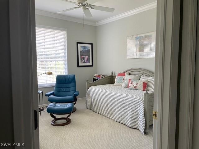 bedroom featuring a ceiling fan, carpet flooring, and crown molding