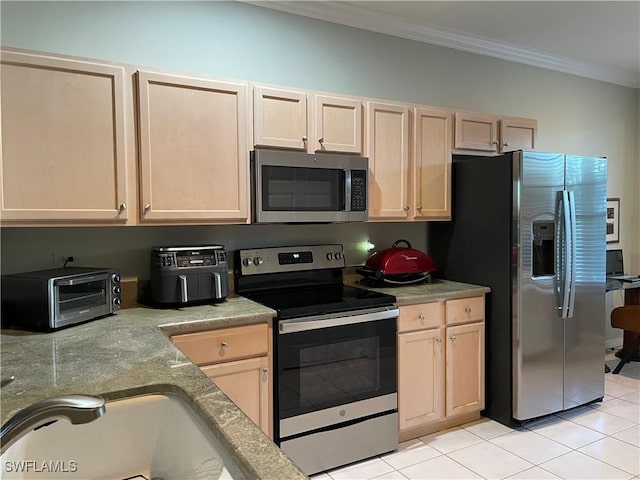 kitchen featuring light tile patterned floors, light brown cabinetry, appliances with stainless steel finishes, and crown molding