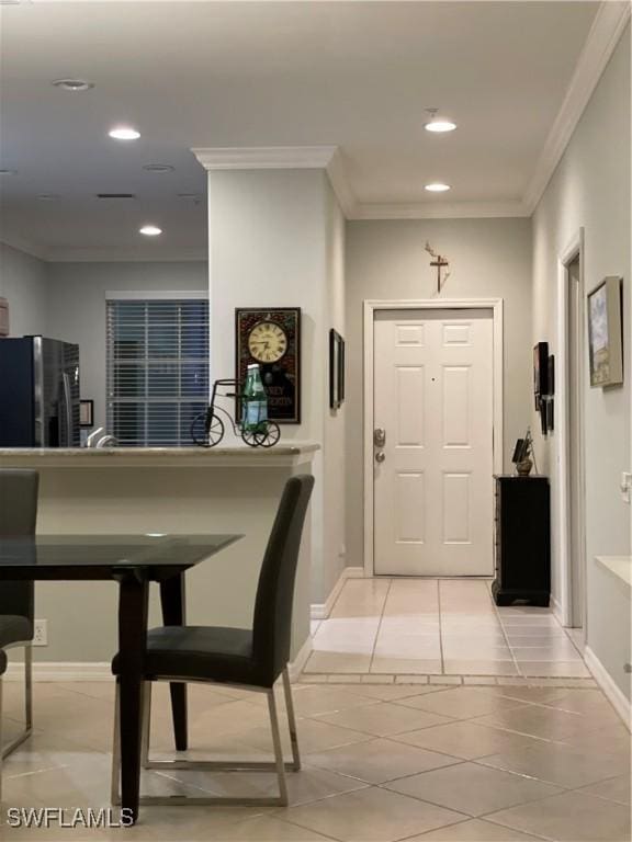 interior space featuring baseboards, recessed lighting, and crown molding