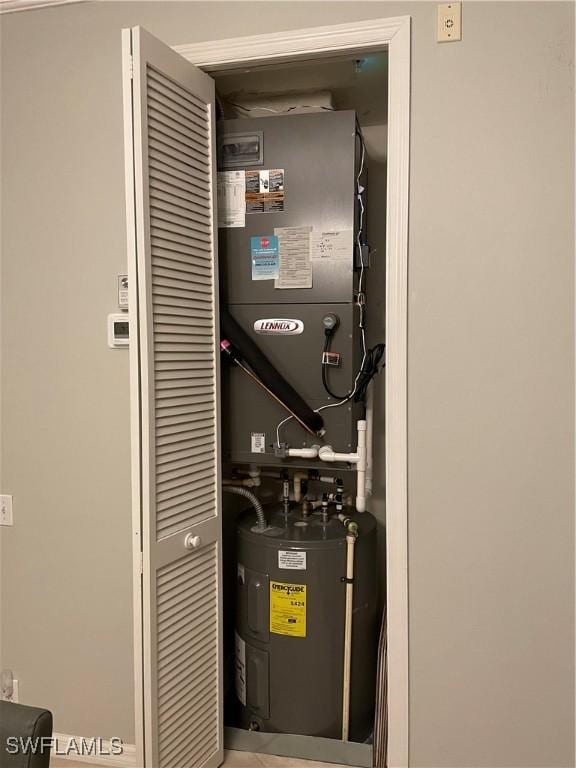 utility room featuring water heater