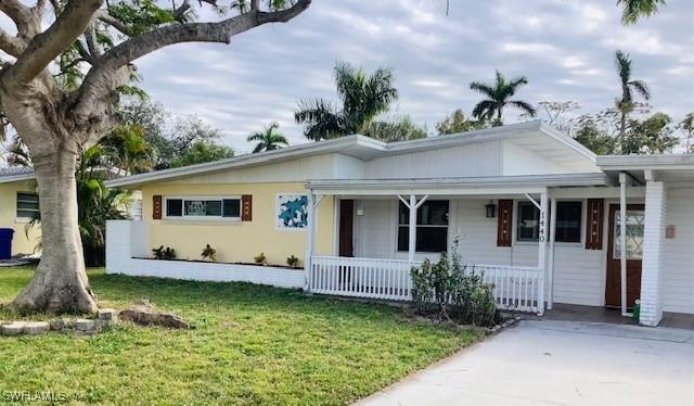 1440 Ricardo Ave, Fort Myers, FL 33901 - single story home with an attached carport, covered porch, and a front yard
