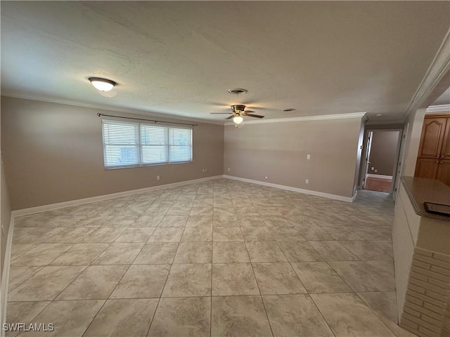 spare room featuring ceiling fan, ornamental molding, light tile patterned floors, and baseboards