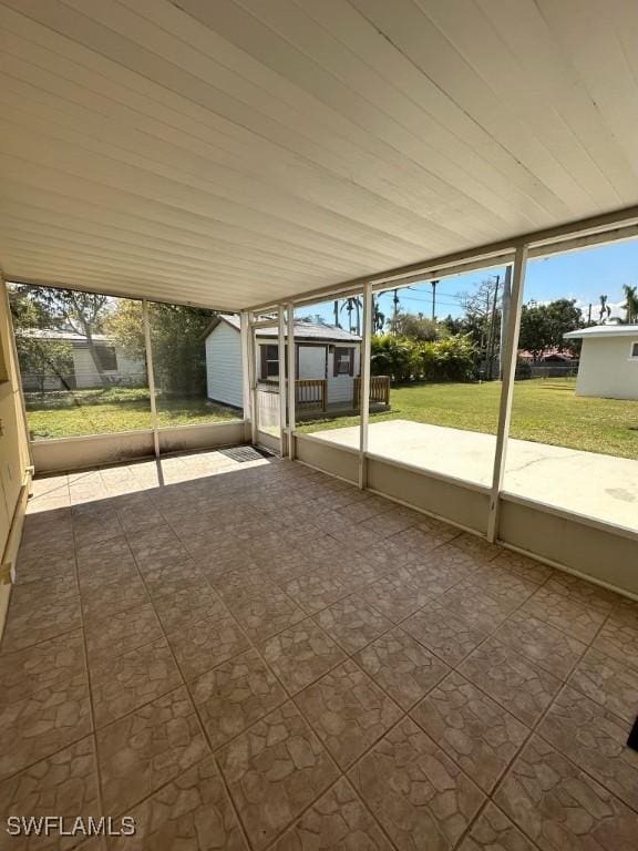 unfurnished sunroom with wooden ceiling