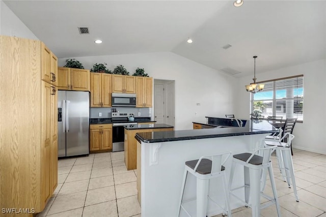 kitchen featuring dark countertops, visible vents, appliances with stainless steel finishes, and light tile patterned floors