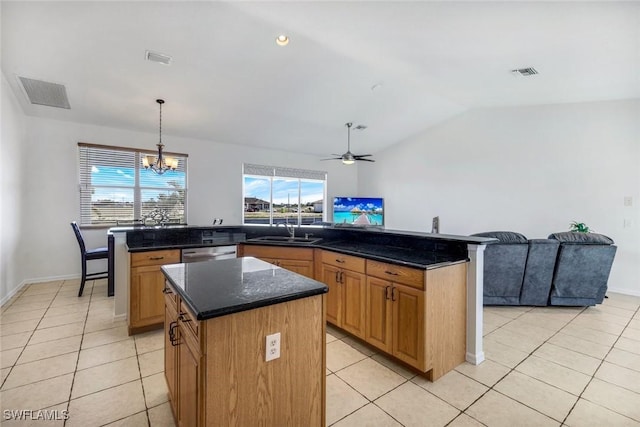 kitchen with light tile patterned floors, visible vents, a kitchen island, and dishwasher