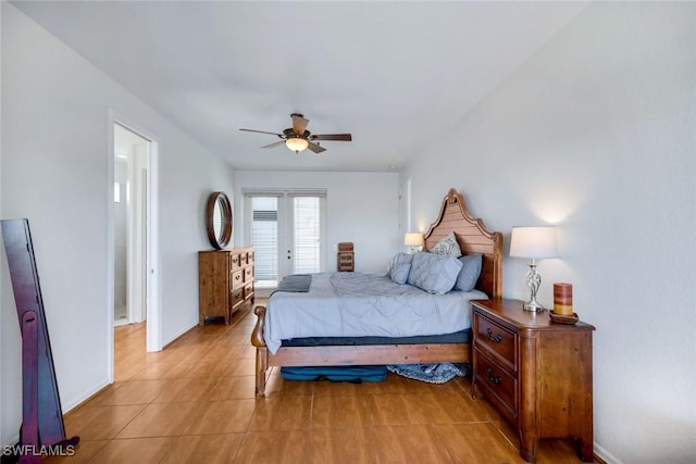 bedroom with light tile patterned floors, a ceiling fan, and baseboards