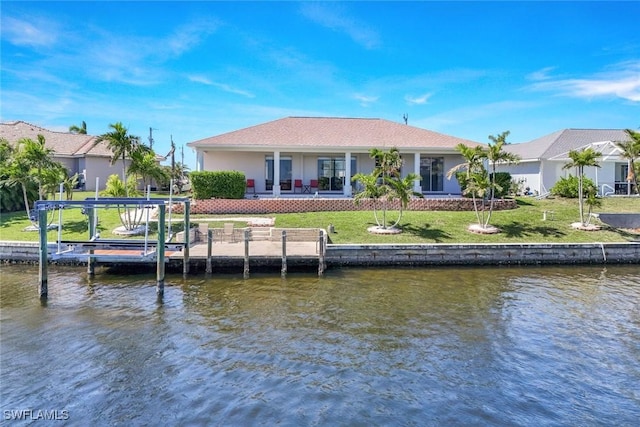 dock area with a yard and a water view