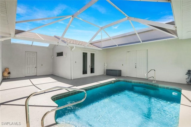 outdoor pool featuring glass enclosure, a patio area, and french doors