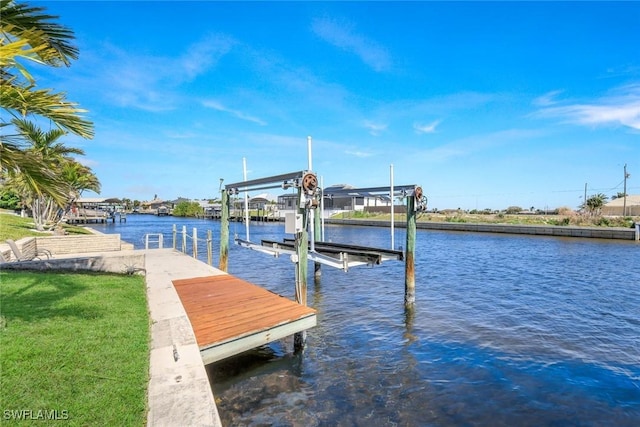 dock area with boat lift and a water view