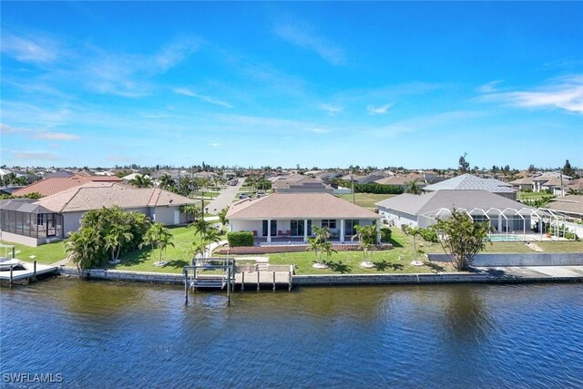 exterior space with a yard, a residential view, and a water view