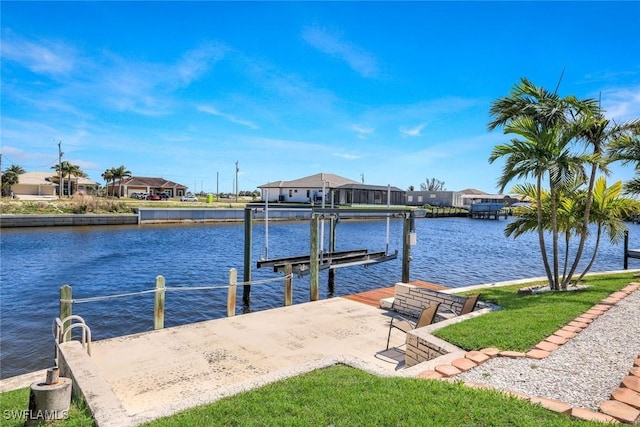 dock area featuring boat lift, a residential view, and a water view