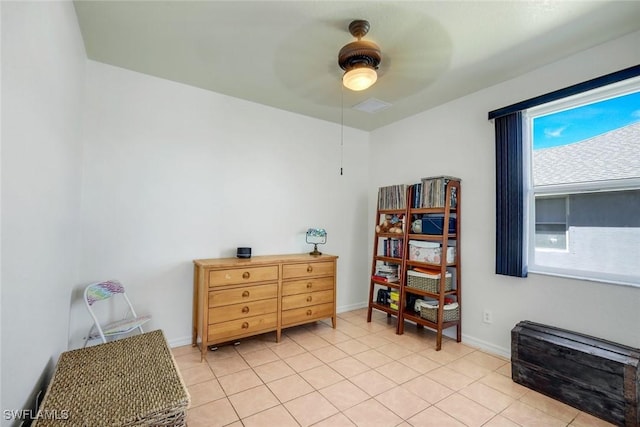 sitting room featuring light tile patterned floors, baseboards, and ceiling fan